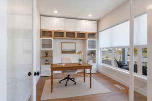 Home office featuring light wood-style floors, recessed lighting, and french doors