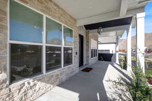 Covered porch featuring a mountain view