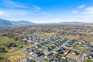 Aerial view of property's location with nearby suburban area and a mountain backdrop