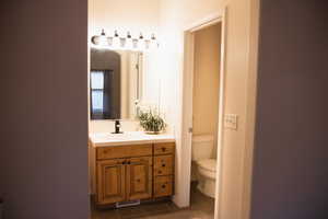 Bathroom with dark tile patterned flooring and vanity