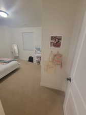 Bedroom with carpet and a textured ceiling