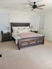 Bedroom with light colored carpet and ceiling fan