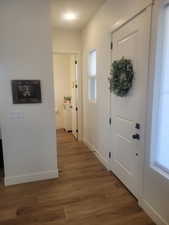 Foyer featuring dark wood-type flooring and baseboards