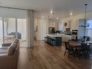 Dining space featuring dark wood-style flooring, a chandelier, and recessed lighting