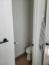 Bathroom featuring baseboards and dark wood finished floors