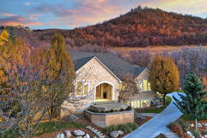 View of front of home featuring a forest view and brick siding