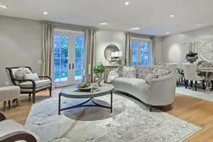 Living room featuring french doors, recessed lighting, and light wood finished floors