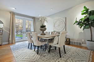 Dining space with light wood-style floors, french doors, and recessed lighting