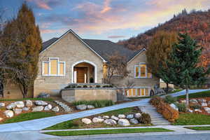 View of front facade with stairway and brick siding