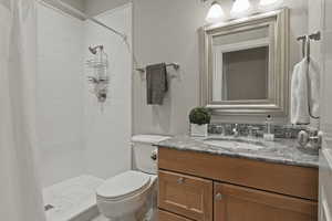 Bathroom with a stall shower and vanity