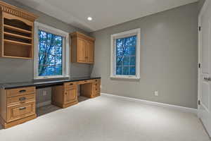 Unfurnished office featuring built in study area, light carpet, and recessed lighting