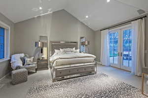 Bedroom with french doors, light colored carpet, high vaulted ceiling, and access to exterior