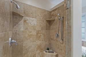 Bathroom featuring a tile shower