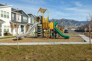 Communal playground featuring a yard and a mountain view