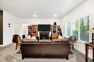 Living area featuring a fireplace and carpet floors