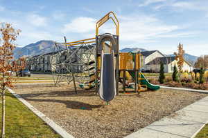 Communal playground with a mountain view and a residential view