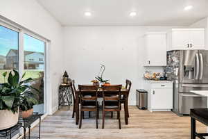 Dining space with light wood-style flooring and recessed lighting