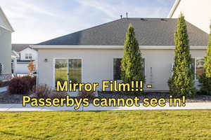 View of side of home featuring stucco siding, a lawn, and a shingled roof