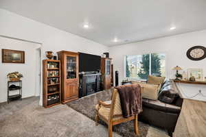 Living area featuring a glass covered fireplace and recessed lighting