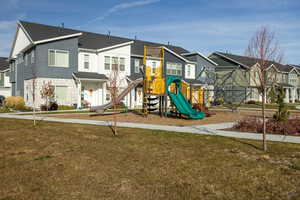 Community play area with a residential view and a yard