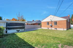 Rear view of house featuring brick siding and a chimney