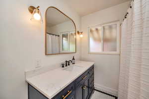 Full bathroom featuring vanity and a shower with shower curtain