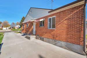 Back of house with brick siding and a patio area