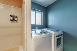 Washroom featuring independent washer and dryer