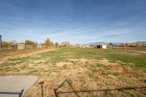 View of yard featuring a view of rural / pastoral area, a mountain view, and an outbuilding