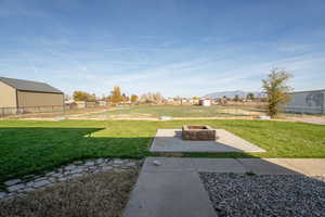 View of yard featuring a patio area, a mountain view, and a fire pit