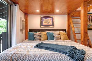 Bedroom featuring recessed lighting, access to exterior, and wood ceiling