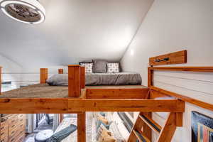 Bedroom with lofted ceiling