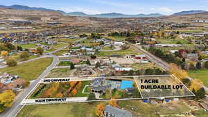 Aerial perspective of suburban area with mountains and property parcel outlined
