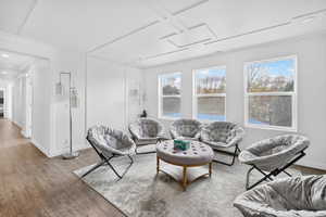 Living room with wood finished floors and coffered ceiling