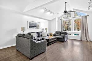 Living room featuring rail lighting, dark wood-style floors, and ceiling fan