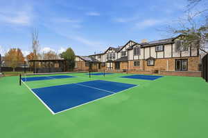 View of tennis court featuring community basketball court and a residential view