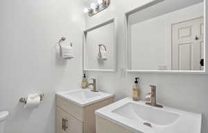Bathroom with two vanities and toilet