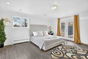 Bedroom with baseboard heating, access to outside, french doors, wood finished floors, and crown molding