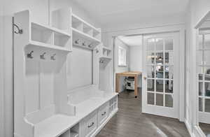 Mudroom with dark wood-style floors and baseboards