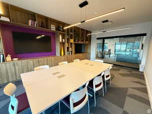 Dining space featuring dark colored carpet