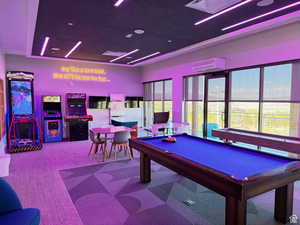 Game room with pool table and a wall mounted AC