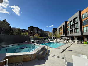Community pool with a hot tub and a patio area