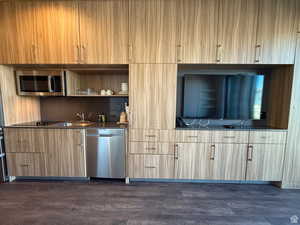 Bar with open shelves, appliances with stainless steel finishes, modern cabinets, dark wood finished floors, and dark countertops