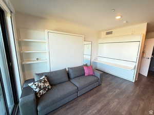 Living area featuring wood finished floors and recessed lighting