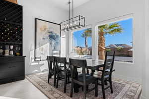 Dining area featuring a chandelier and baseboards