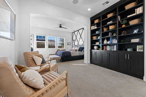 Bedroom with recessed lighting, light carpet, and arched walkways