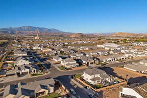 Aerial overview of property's location featuring a mountain backdrop and nearby suburban area