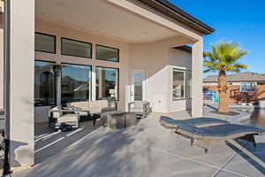 View of patio with an outdoor hangout area