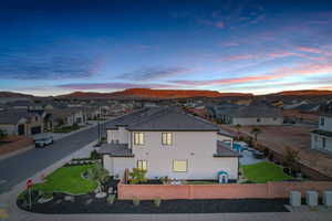 View of side of home with a residential view, a fenced backyard, stucco siding, and a mountain view