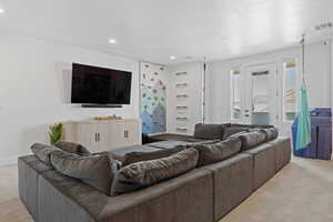 Living room with light colored carpet and recessed lighting